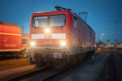 Train at railroad station platform against sky