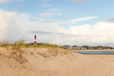 Dune, lighthouse and city of hörnum at sylt - southern village at german north sea island