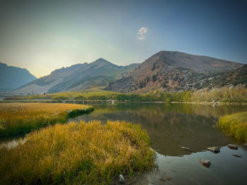 Scenic view of lake and mountains against sky