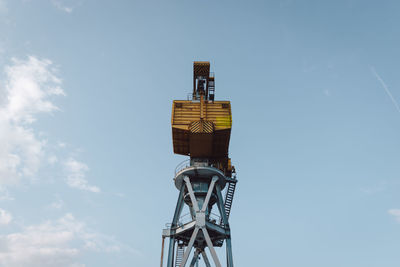 Low angle view of communications tower against sky