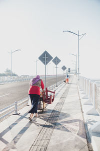 Rear view of man walking on street