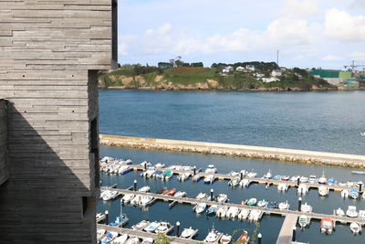 Scenic view of sea by buildings against sky