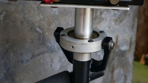 Close-up of machine part against wall