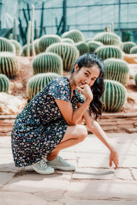 Portrait of young woman sitting outdoors