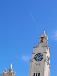 Low angle view of clock tower against blue sky