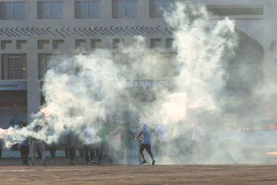 People on smoke emitting from city