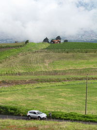 Car on field against sky