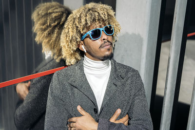 Portrait of young man wearing sunglasses standing outdoors