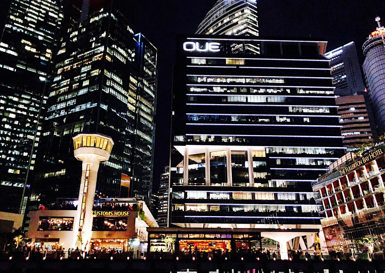 LOW ANGLE VIEW OF ILLUMINATED MODERN BUILDINGS IN CITY