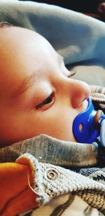 Close-up portrait of baby lying down