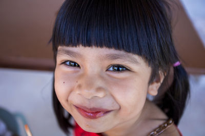 Close-up portrait of smiling cute girl