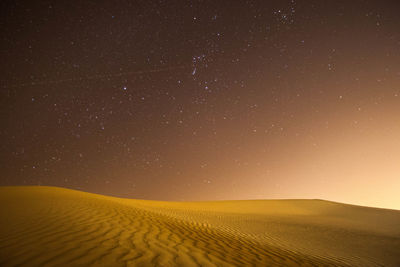 View of calm desert against the sky