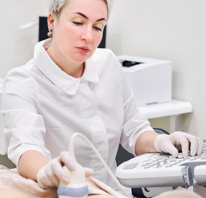 Gynecologist examining patient at hospital