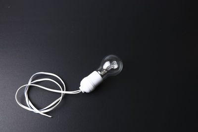 High angle view of light bulb against black background