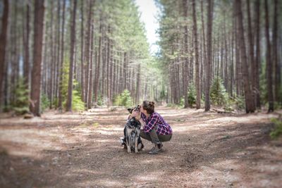 Rear view of couple sitting in forest