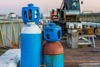 Close-up of blue container on table in city