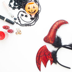 Directly above shot of halloween props on white background