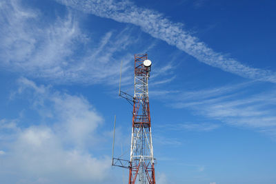 Low angle view of communications tower against blue sky