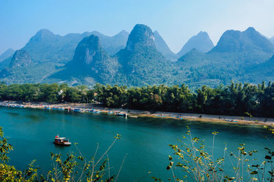 Scenic view of lake and mountains against clear sky