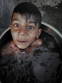 Portrait of shirtless boy in water