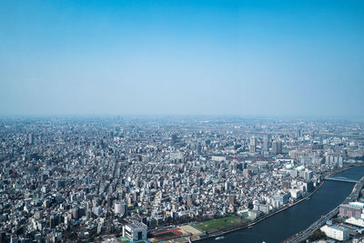 High angle view of city buildings against clear sky