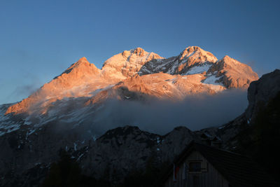 Scenic view of snowcapped mountains against clear sky