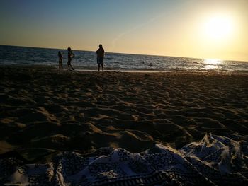 Silhouette of people on beach