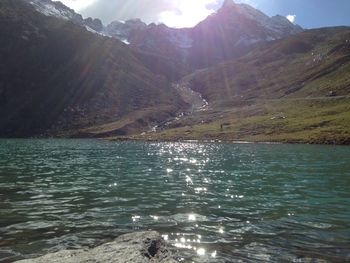 Scenic view of mountains and river against sky