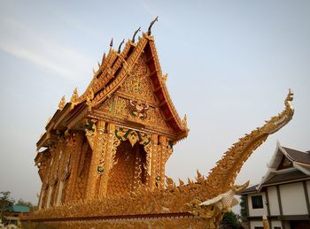 Low angle view of gold colored built structure temple