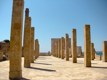 Panoramic view of columns against clear blue sky