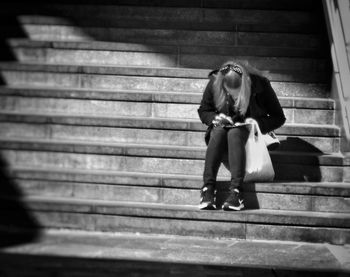 Full length of woman standing by railing