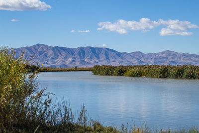 Scenic view of lake and mountains against sky