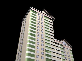 Low angle view of modern building against sky at night