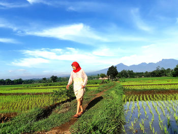 Man standing on field against sky