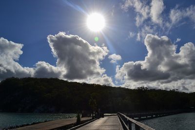 Scenic view of river against cloudy sky