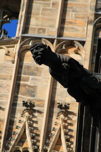 Low angle view of statue against building in city
