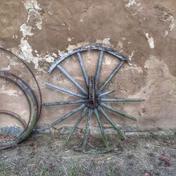 High angle view of old wheel on wall