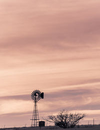 Low angle view of silhouette windmill against sky during sunset