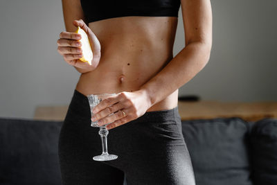 Midsection of woman holding drink