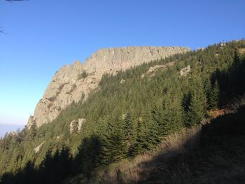 Low angle view of mountain against clear blue sky