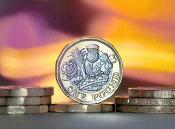 Close-up of coins on metal structure