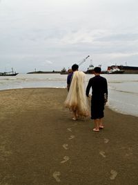 Men walking at beach