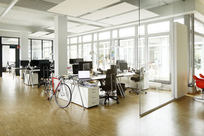 Bicycle at desk in open plan office