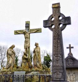 Statue against sky at cemetery