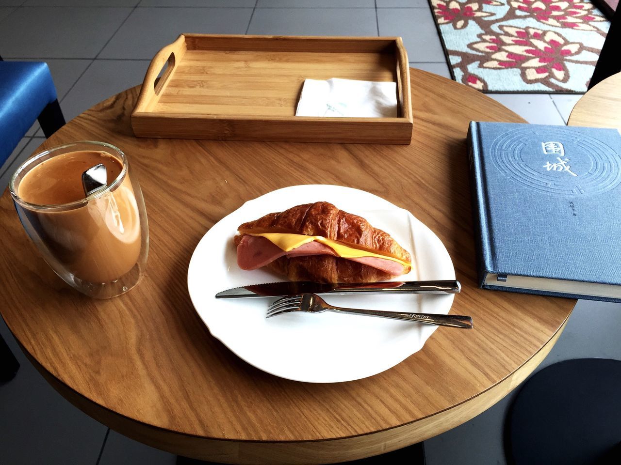 indoors, table, food and drink, plate, food, still life, freshness, high angle view, ready-to-eat, sweet food, wood - material, indulgence, fork, dessert, serving size, drink, spoon, no people, unhealthy eating, refreshment