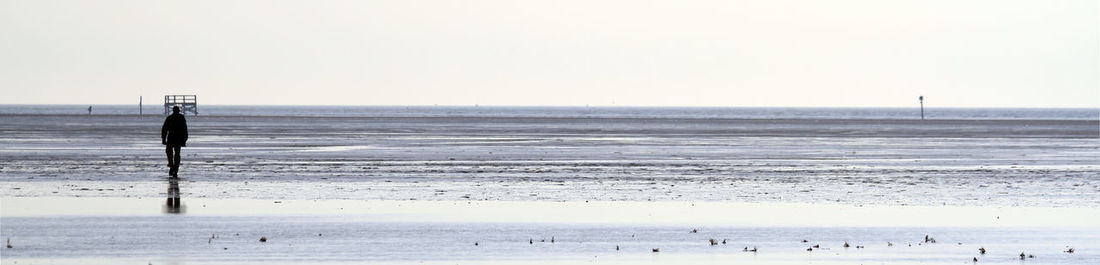 Scenic view of sea against clear sky during winter