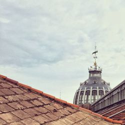 Low angle view of building against cloudy sky