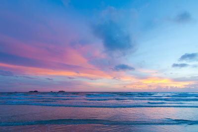 Scenic view of calm sea against cloudy sky