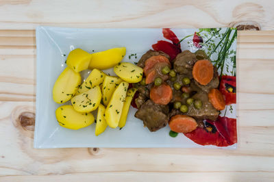 High angle view of fruits in plate on table