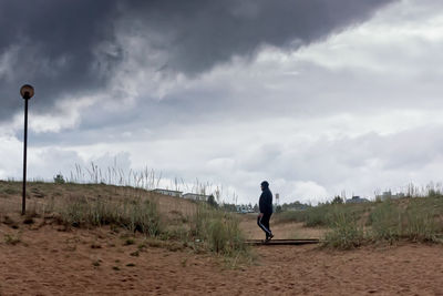 Man on beach against sky